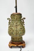 A Chinese archaistic bronze table lamp on stand 36cm high