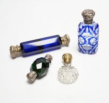 Four assorted Victorian white or gilt metal mounted cut glass scent bottles, including double