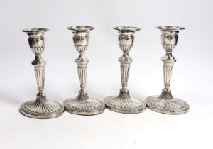 A set of four Elizabeth II silver candlesticks, with fluted stems and bases, C.J. Vander Ltd,