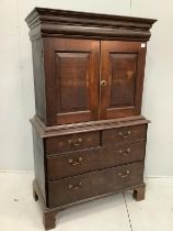 An 18th century oak cabinet on chest, width 107cm, depth 52cm, height 178cm