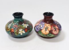 Two small Moorcroft squat vases, in Pansy and Carousel patterns, 10.5cm