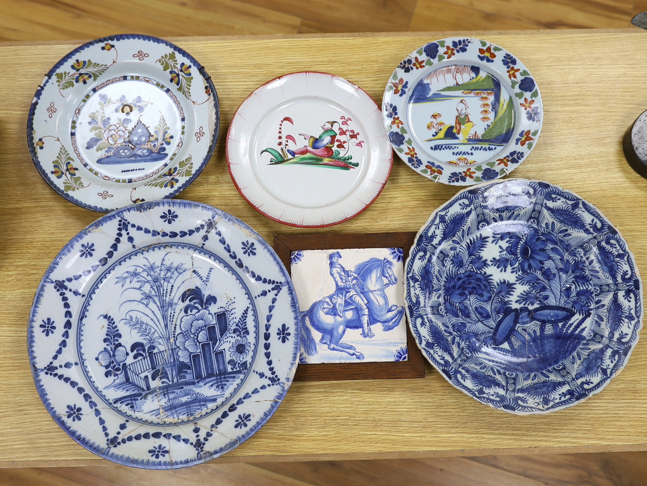 Two 18th century Delft blue and white dishes, a Delft polychrome dish, an English delftware plate, a