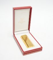 A Cartier gold plated lighter, with box and certificate.