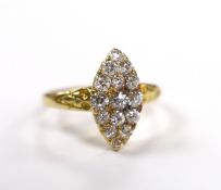 An early 20th century yellow metal and old round cut diamond cluster set marquise shaped ring,