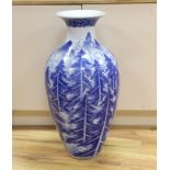 A large Japanese Arita blue and white vase, late 19th century, decorated with pine trees and