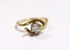 A yellow metal and solitaire diamond set ring, with crossover shoulders, size M, gross weight 3.5