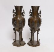 A pair of Japanese bronze vases on tripod legs, 24.5cm
