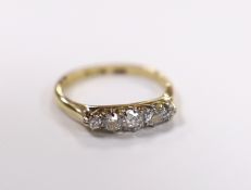 A 1920's 18ct, plat and graduated five stone diamond set half hoop ring, size K/L, gross weight 2.