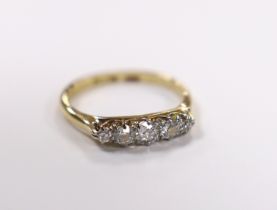 A 1920's 18ct, plat and graduated five stone diamond set half hoop ring, size K/L, gross weight 2.