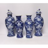 Two pairs of late 19th/early 20th century Chinese blue and white prunus vases, one pair with covers,