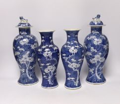 Two pairs of late 19th/early 20th century Chinese blue and white prunus vases, one pair with covers,