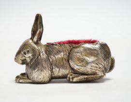 An Edwardian novelty silver mounted pin cushion, modelled as a recumbent rabbit, Henry Matthews,