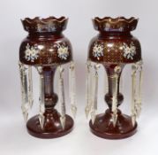 A pair of late 19th century ruby glass floral enamelled table lustres, 35.5cm high