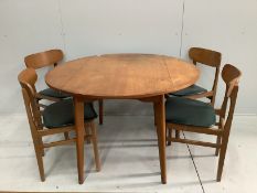 A mid century teak circular drop leaf dining table, diameter 114cm extended, height 73cm and four