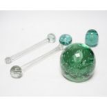 Three 19th century green glass Stourbridge dumps, one large, 12cm diam. and two small, 6cm diam.,