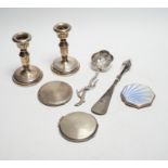 Three silver compacts including one enamelled, a pair of silver mounted dwarf candlesticks, 10.2cm
