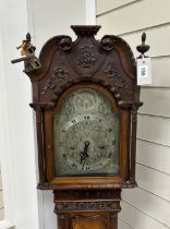 A 1920's George III style mahogany grandmother clock with arched silvered dial and three train