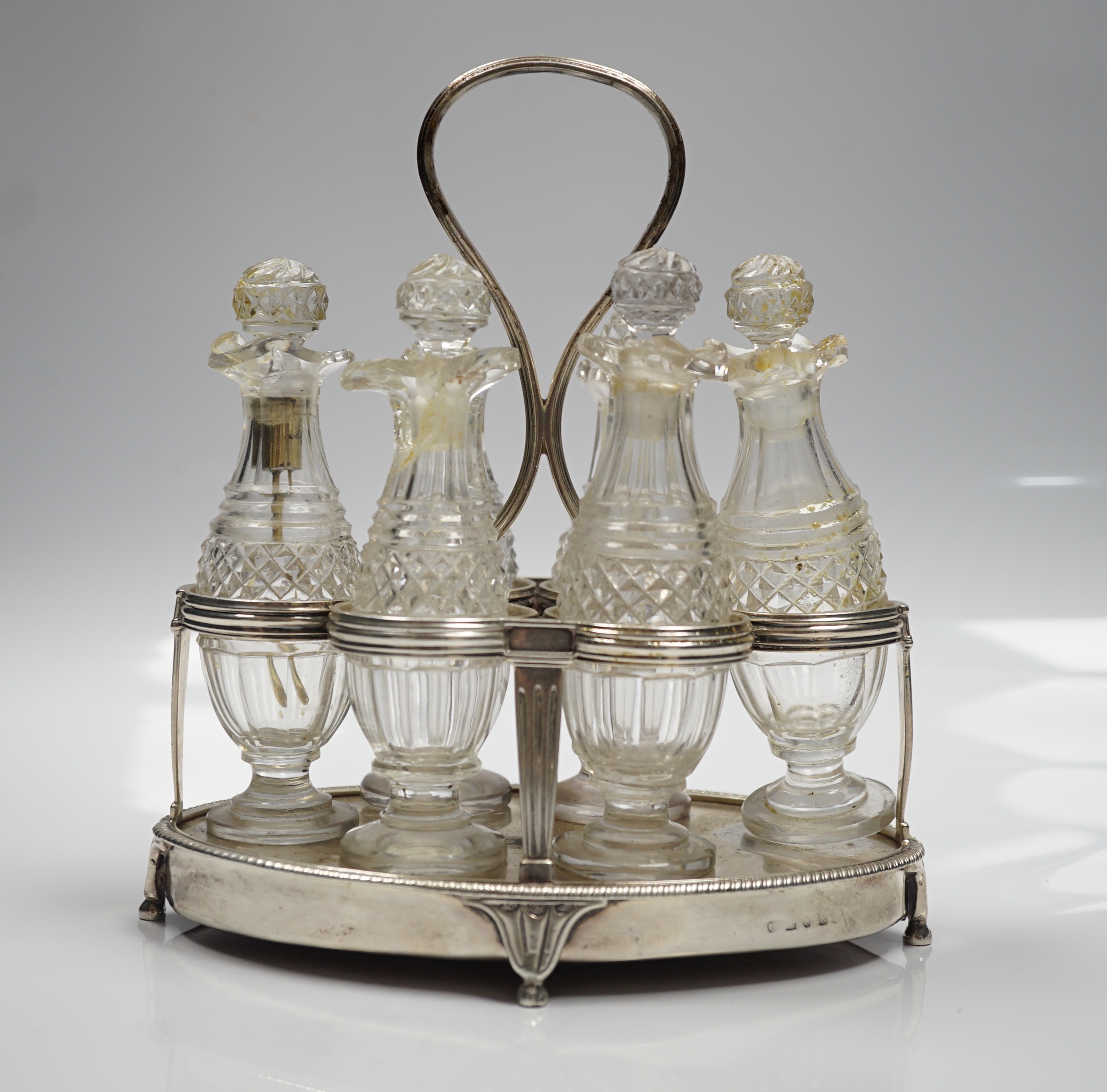 A George III silver mounted oval cruet stand, maker P?, London, 1802, with reeded ring handle and