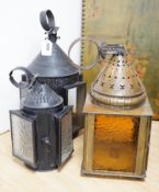 Three 19th century candle lanterns, one brass 45cm high, two black painted steel 45cm & 35cm high