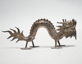 A Chinese white metal toothpick holder, modelled as a free standing model of a dragon, 12.4cm.