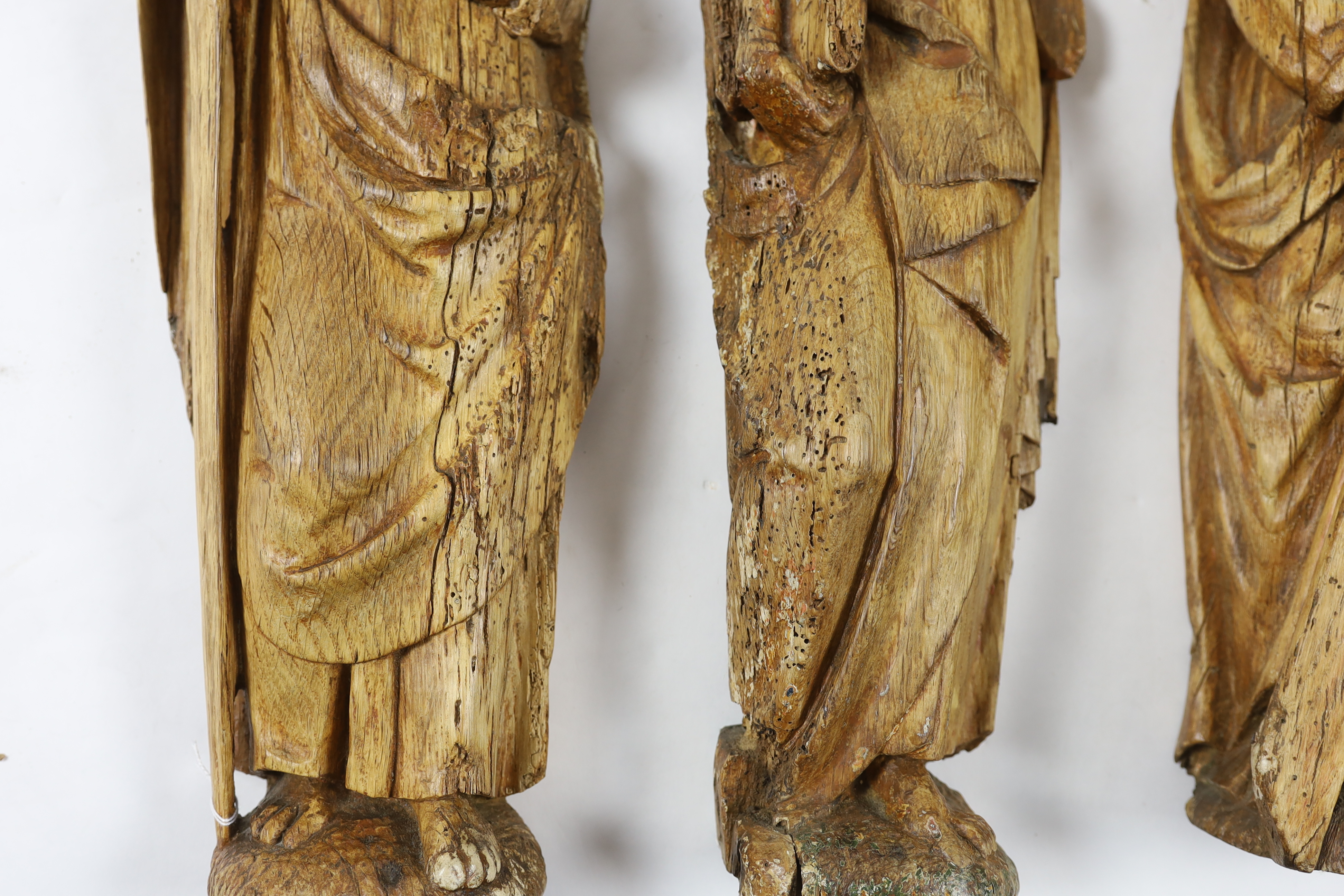 A set of three 18th century Continental carved wood figures of Saints, holding a cross, a bible - Image 2 of 3