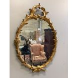 A reproduction giltwood and composition oval wall mirror, width 80cm, height 116cm