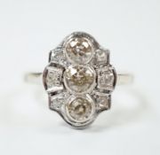 An Art Deco pierced white metal and millegrain set diamond cluster ring, size L, gross weight 3.2