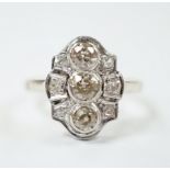 An Art Deco pierced white metal and millegrain set diamond cluster ring, size L, gross weight 3.2