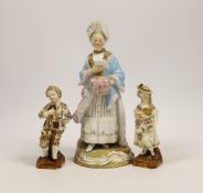A Meissen figure of a lady, model no D66, 19.5cm, and a pair of smaller German figures