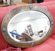 An Arts and Crafts style hammered copper mirror