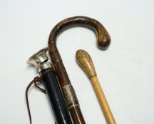 Three various walking canes including an inlaid tortoiseshell 'hidden compartment' cane, (two silver
