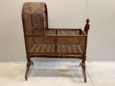 A George IV caned mahogany rocking crib, width 112cm, depth 51cm, height 135cm
