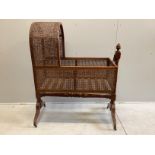 A George IV caned mahogany rocking crib, width 112cm, depth 51cm, height 135cm