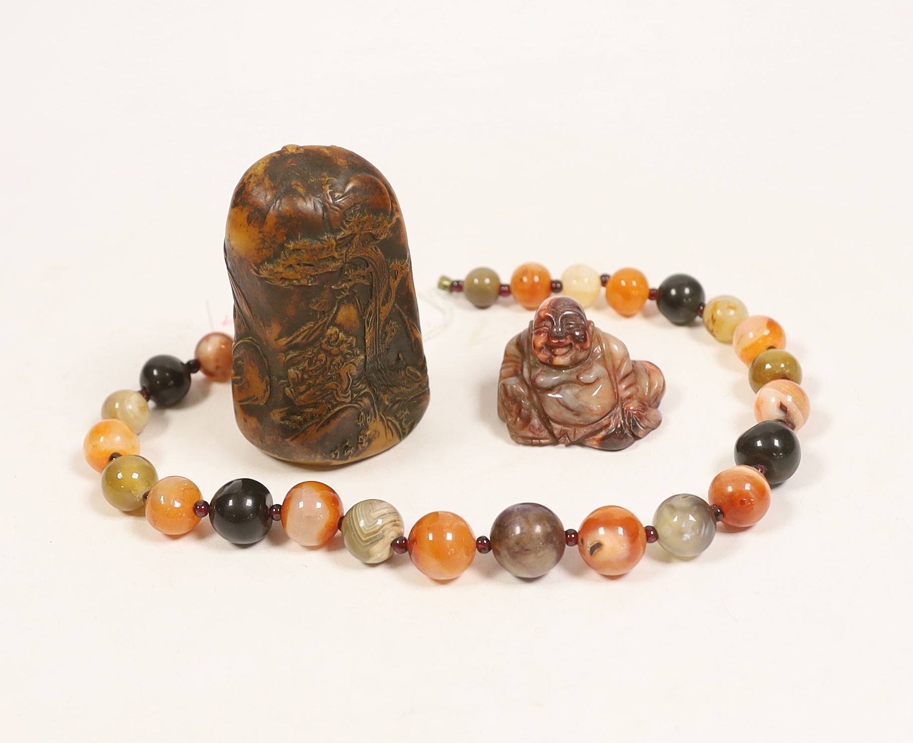 An agate bead necklace, a Chinese soapstone seal and a miniature carved agate Buddha, 4cm