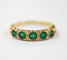 A modern 18ct gold and five stone emerald set half hoop ring, with diamond chip spacers, size K/L,