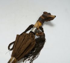 A Victorian silk parasol, carved ‘dogs head’ handle with articulated jaw and telescopic bamboo