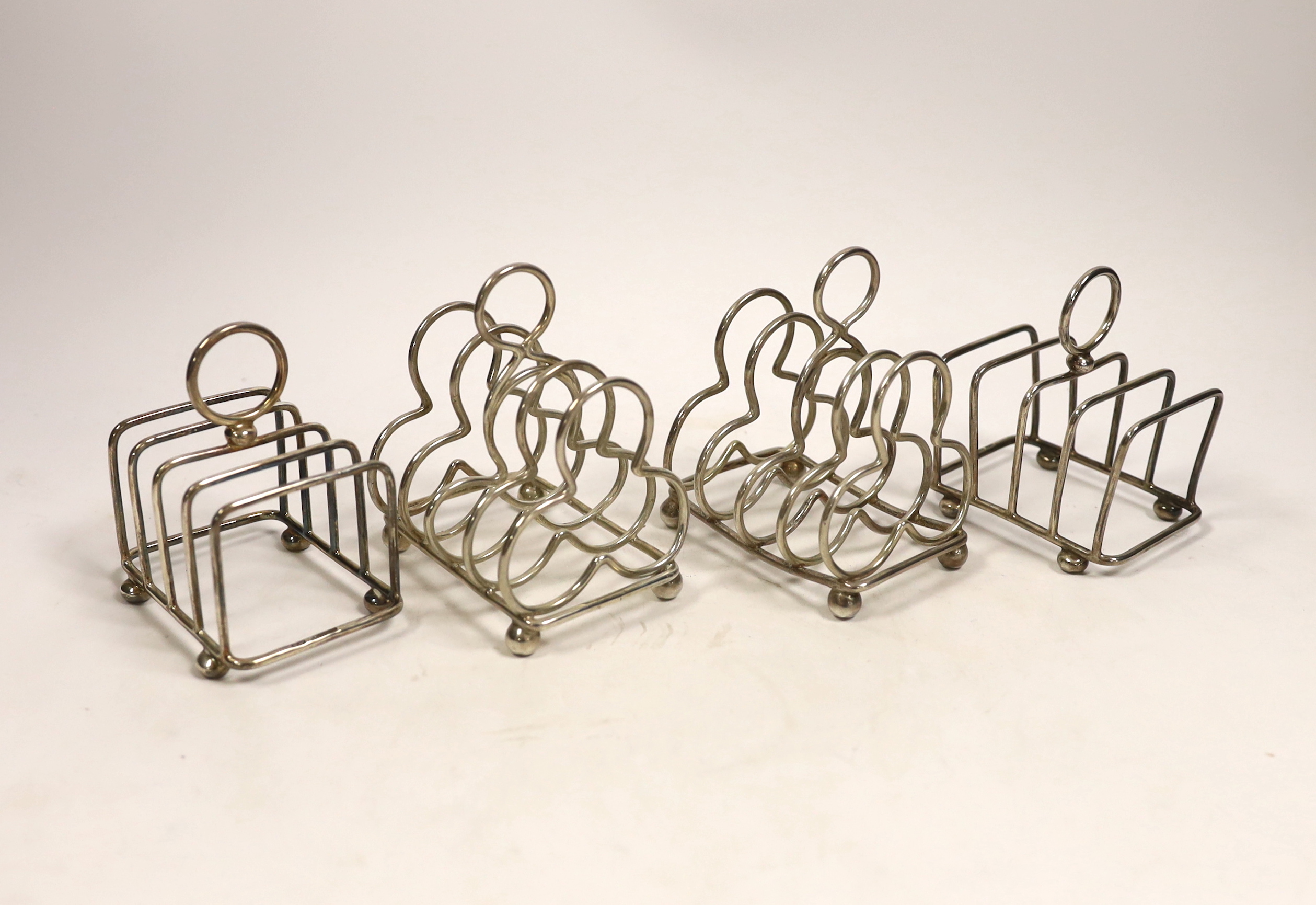 Two pairs of silver five bar toast racks, Lee & Wigfull, Sheffield, 1904 and cusped shaped,