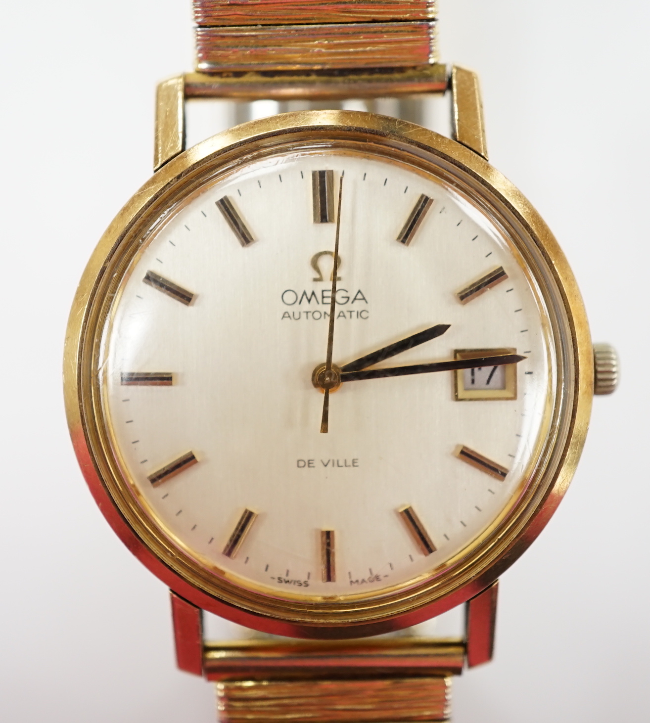 A gentleman's yellow metal Omega De Ville automatic wrist watch, with baton numerals and date