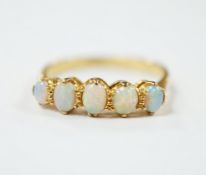 An 18ct and graduated five stone white opal set half hoop ring, size O, gross weight 2.7 grams.