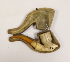 A cased Meerschaum smoker’s pipe in the form a boot and hand