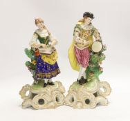 A pair of Continental porcelain figures of musicians, pseudo Derby marks, 27cm