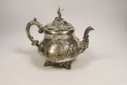 A Victorian embossed silver pyriform teapot by Robert Harper, London, 1869, gross weight 23.4oz,