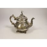 A Victorian embossed silver pyriform teapot by Robert Harper, London, 1869, gross weight 23.4oz,