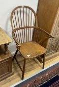 An elm and beech Windsor comb back elbow chair, width 65cm, depth 42cm, height 108cm
