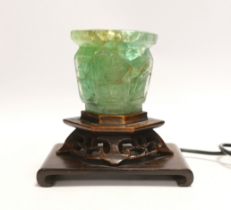 A Chinese green quartz and carved hardwood table lamp,