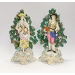 A pair of Continental porcelain figures of gardeners, pseudo Chelsea marks, 28cm high