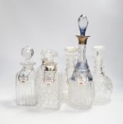 A pair of silver mounted decanters and four other decanters, five with Staffordshire decanter