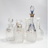 A pair of silver mounted decanters and four other decanters, five with Staffordshire decanter