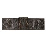 A 17th century French carved walnut triptych panel, formed from several associated sections, with