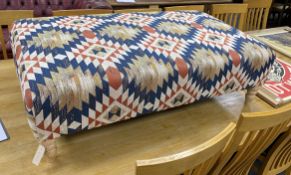 A large contemporary rectangular footstool upholstered in Kilim style polychrome fabric on turned